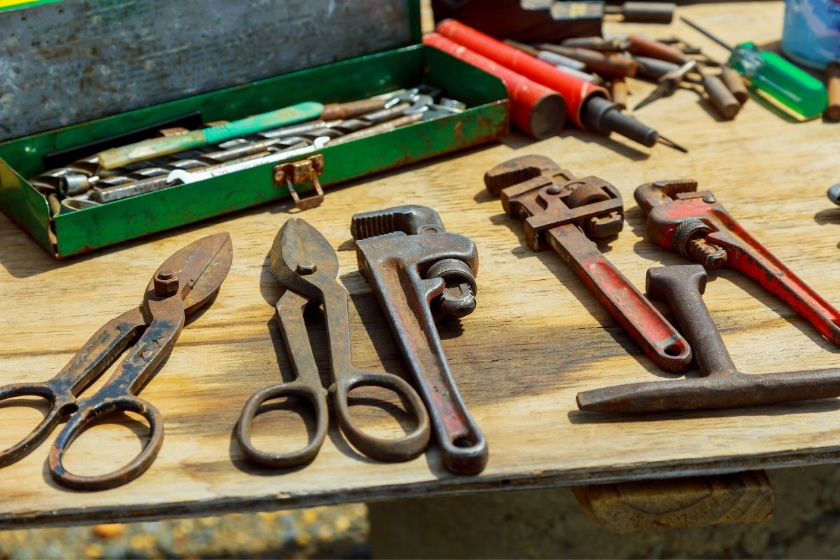 A table displaying an assortment of tools, including wrenches, screwdrivers, and pliers, arranged neatly.